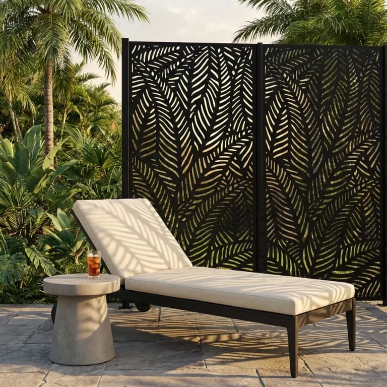 A decorative leaf-pattern privacy screen beside an outdoor lounge setting in Adelaide